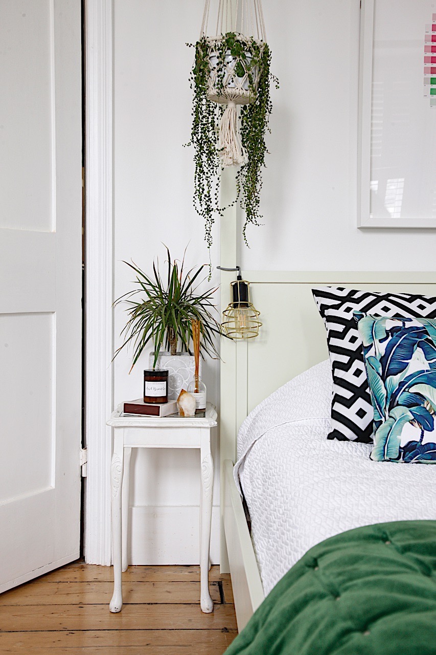White and green bedroom with upcycled bedside table