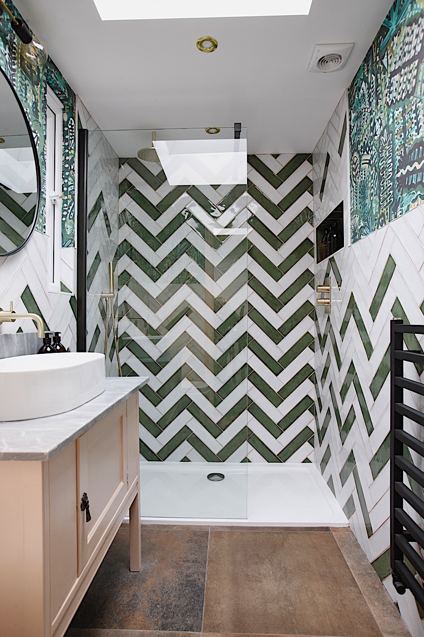 Bold shower room with zig zag herringbone tile and vintage washstand